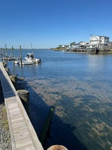 a view of a terrace with lawn chairs