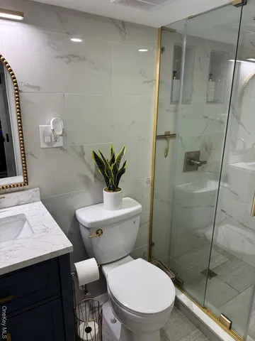 a bathroom with a toilet a sink and a mirror