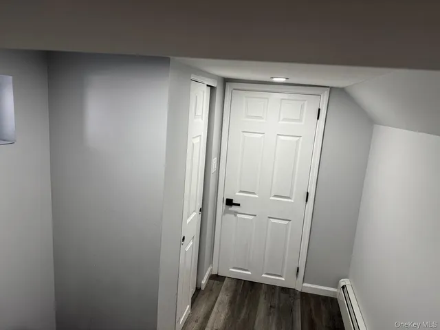 a view of a room with wooden floor and window