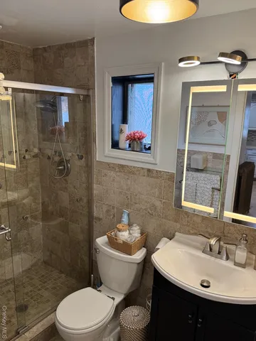 a bathroom with a sink toilet and shower