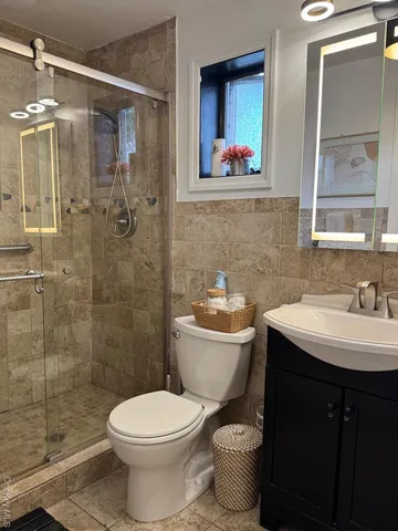 a bathroom with a toilet sink and mirror