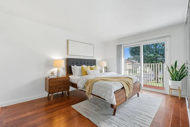 a bed room with a bed and a chair