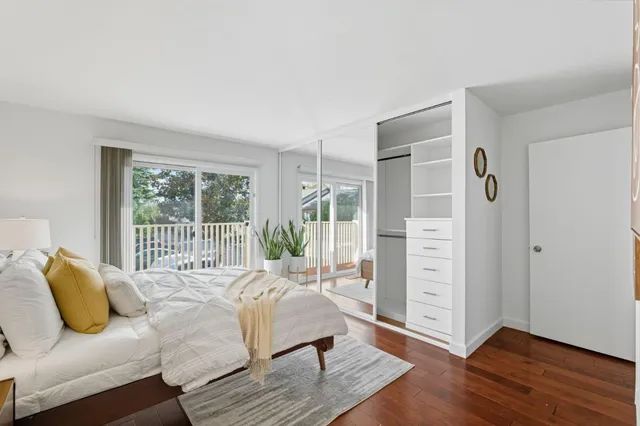 a bedroom with furniture and a large window