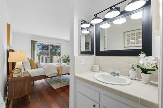 a bathroom with a granite countertop sink and a mirror