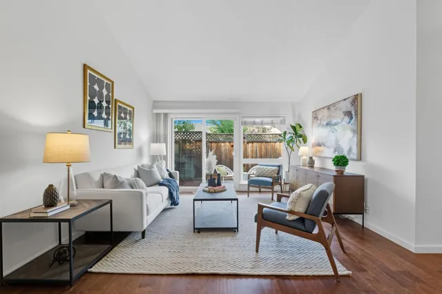 a living room with furniture and a lamp