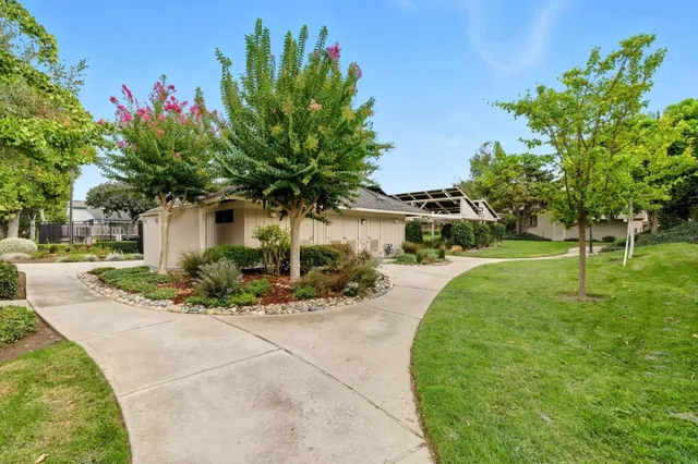 a front view of a house with a yard and a garage