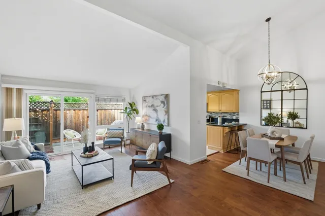 a living room with furniture dining table and a flat screen tv