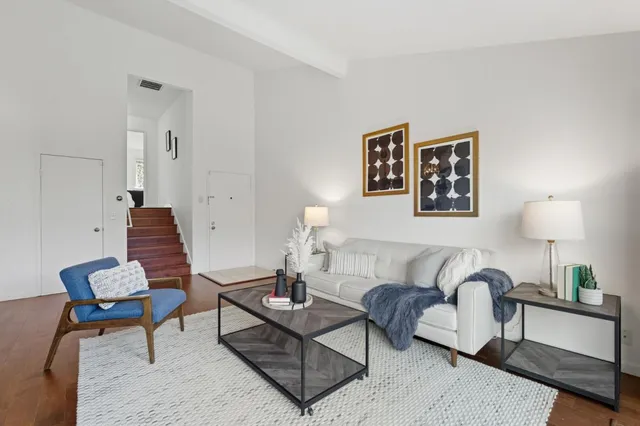 a living room with furniture and a lamp