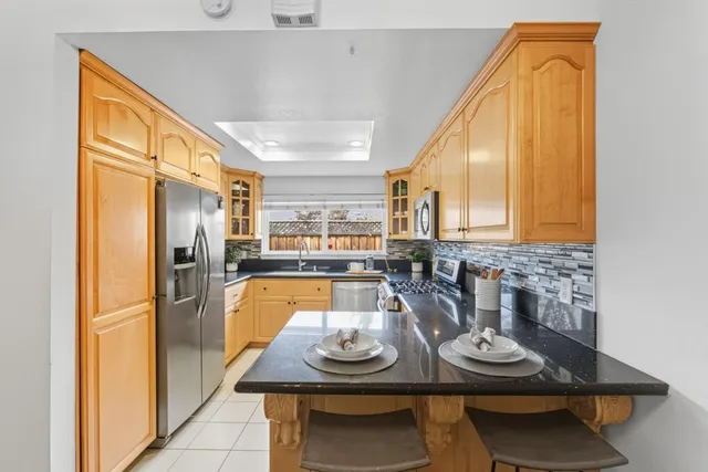 a kitchen with furniture and a refrigerator