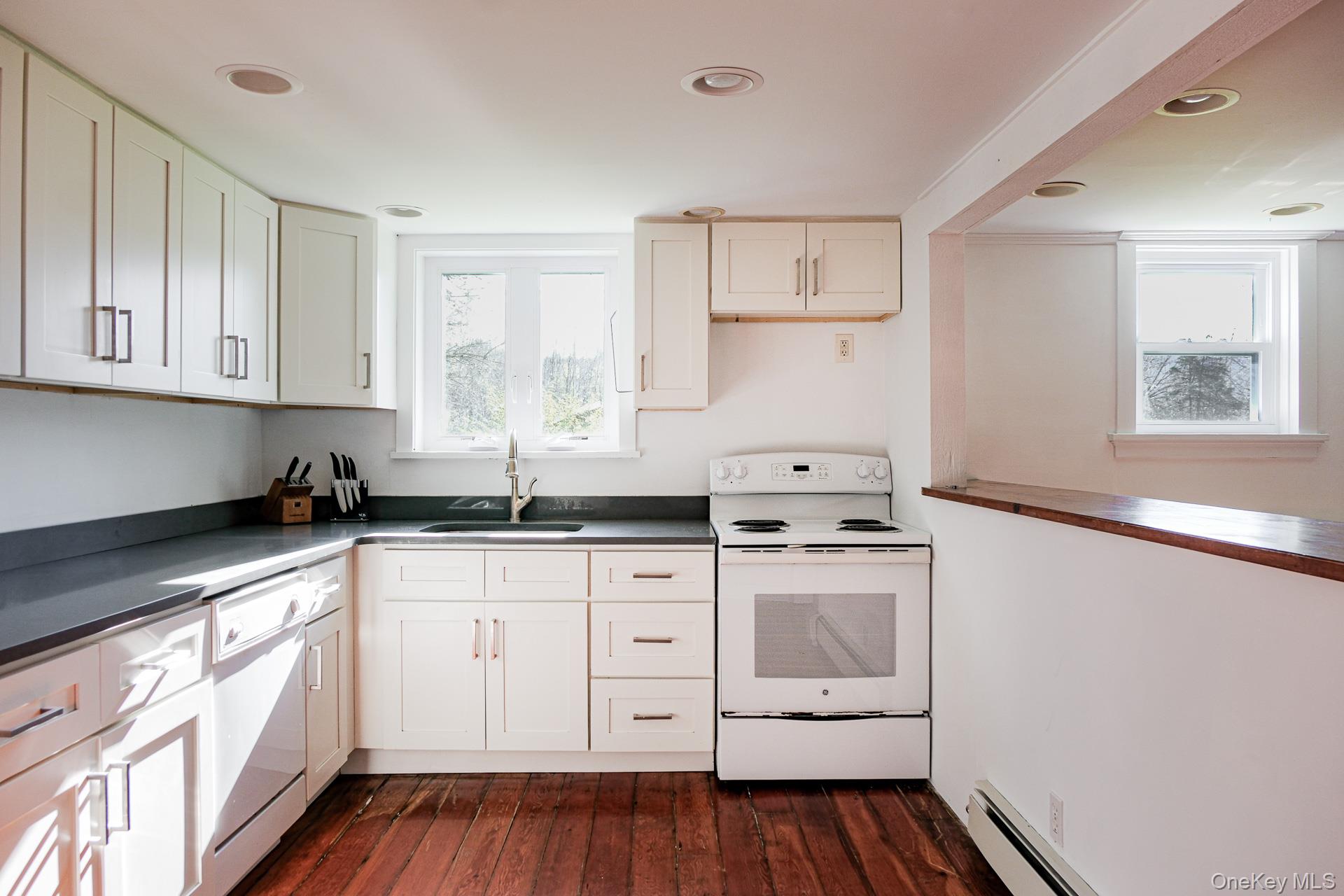 151 Benson Hill Road Wassaic, NY 12592 - Photo 30 of 45 a kitchen with cabinets appliances a sink and a window