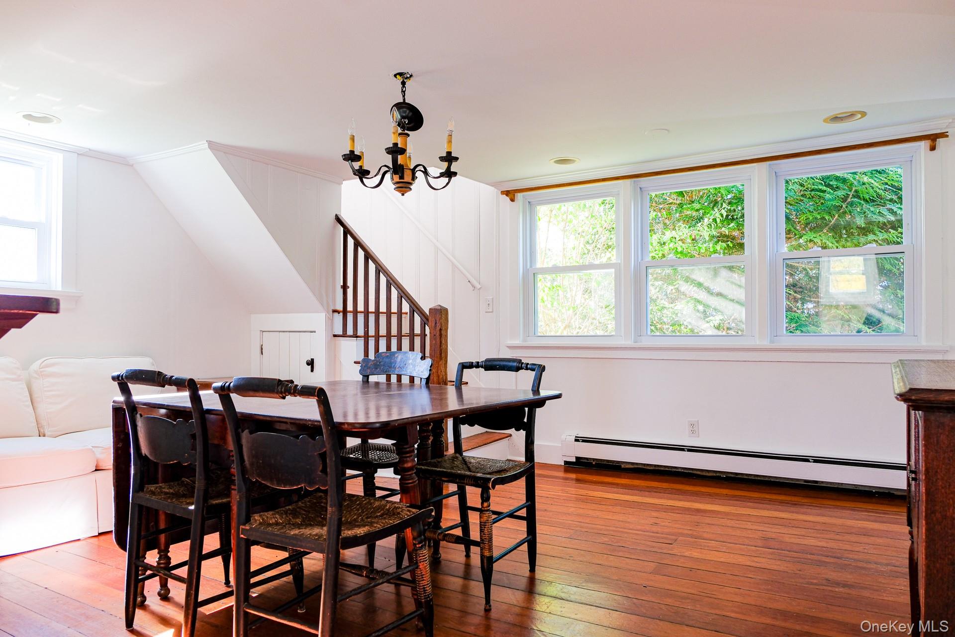 151 Benson Hill Road Wassaic, NY 12592 - Photo 31 of 45 a view of a dining room with furniture window and wooden floor