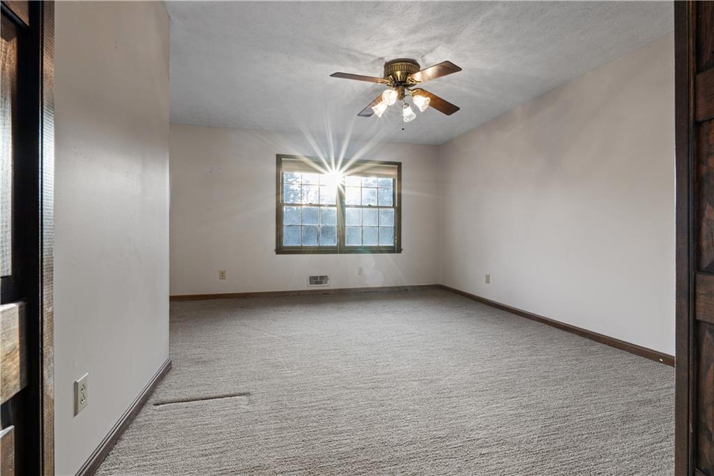 7085 Hobgood Road Fairburn, GA 30213 - Photo 11 of 40 a view of a livingroom with a ceiling fan and window