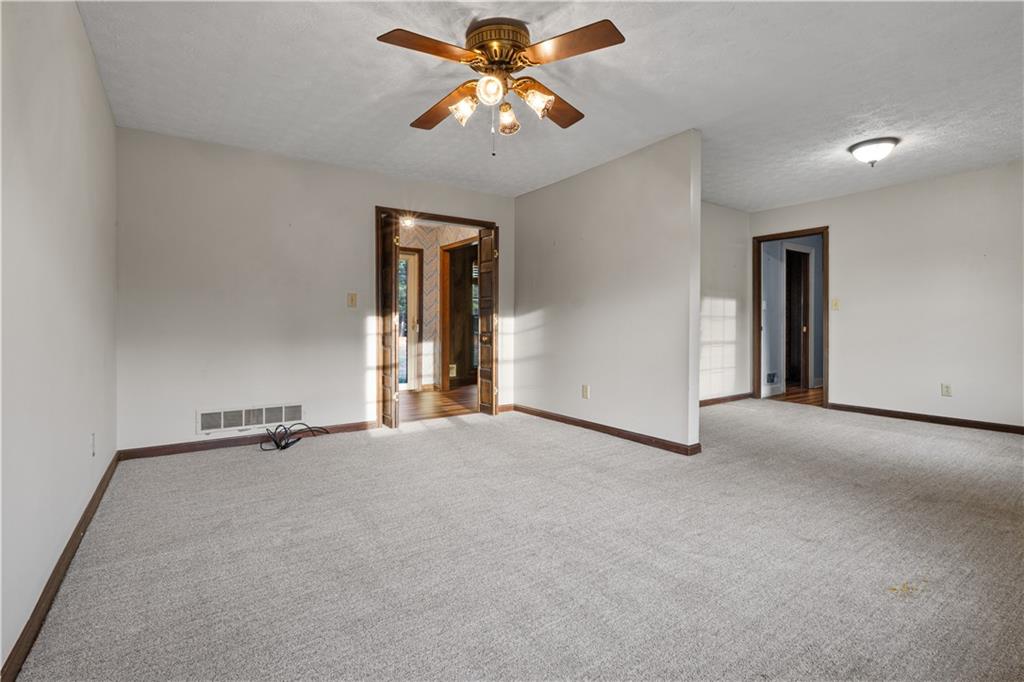 7085 Hobgood Road Fairburn, GA 30213 - Photo 13 of 40 a view of an empty room and chandelier fan