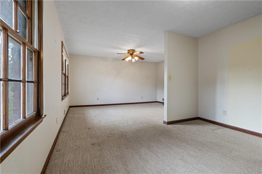 7085 Hobgood Road Fairburn, GA 30213 - Photo 14 of 40 a view of a livingroom with wooden floor and stairs