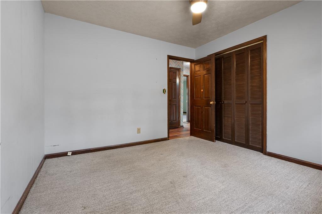 7085 Hobgood Road Fairburn, GA 30213 - Photo 17 of 40 an empty room with closet area