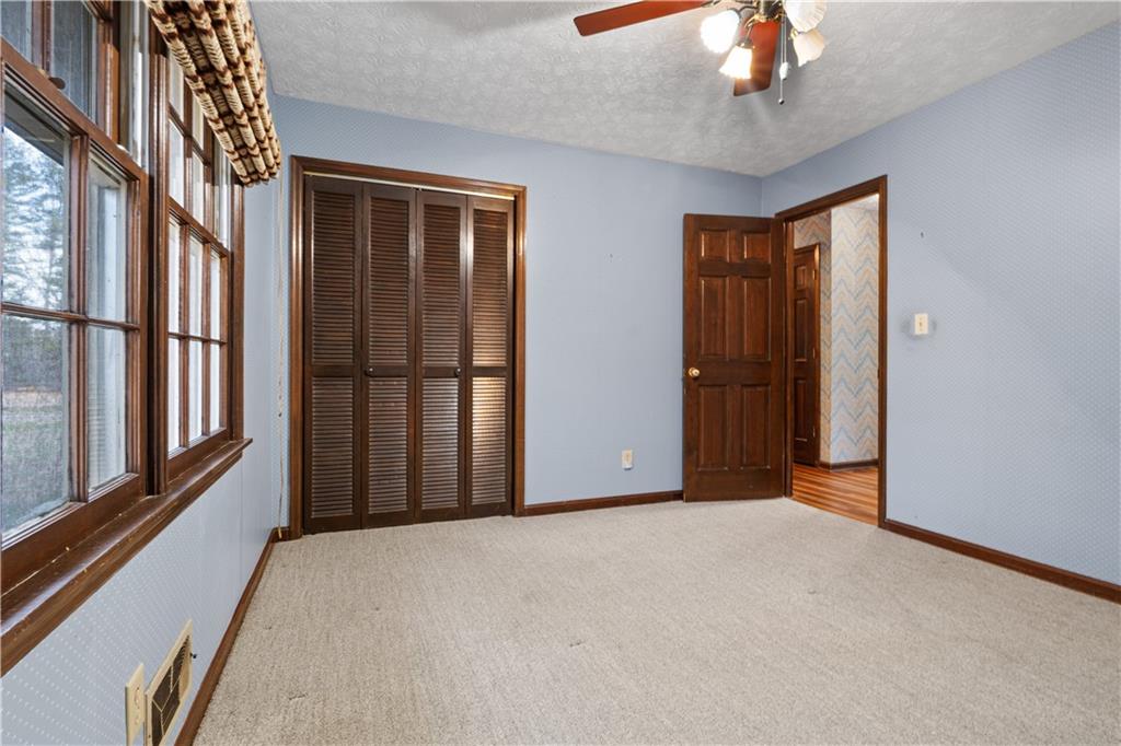 7085 Hobgood Road Fairburn, GA 30213 - Photo 19 of 40 a view of a livingroom with a ceiling fan and window