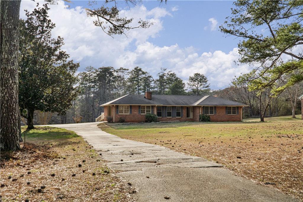 7085 Hobgood Road Fairburn, GA 30213 - Photo 2 of 40 a view of a house with a yard