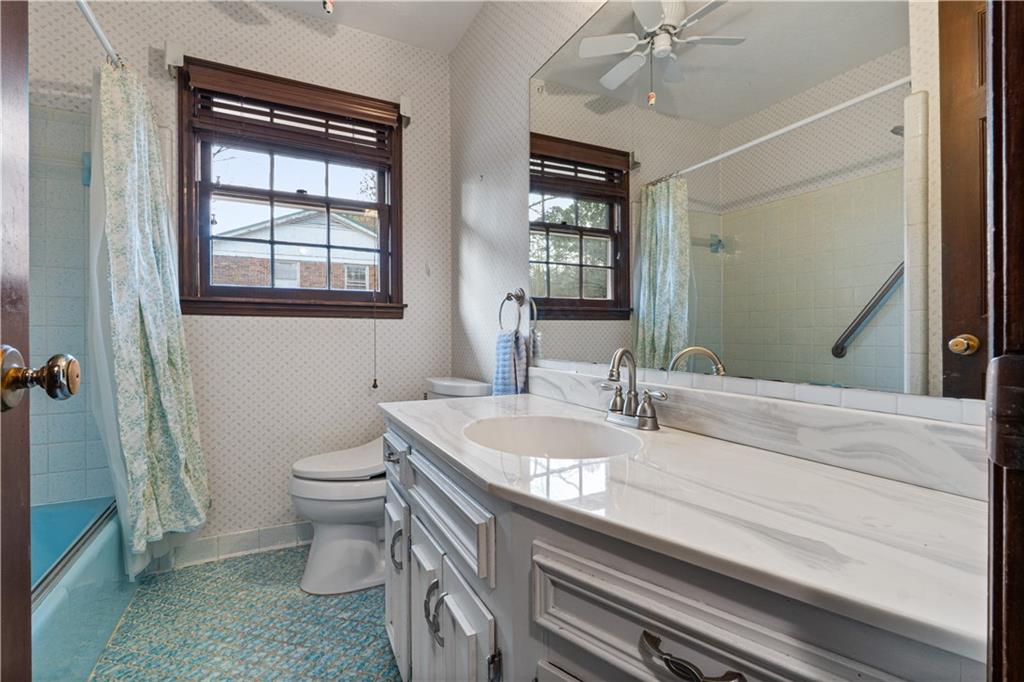 7085 Hobgood Road Fairburn, GA 30213 - Photo 21 of 40 a bathroom with a sink a toilet and mirror