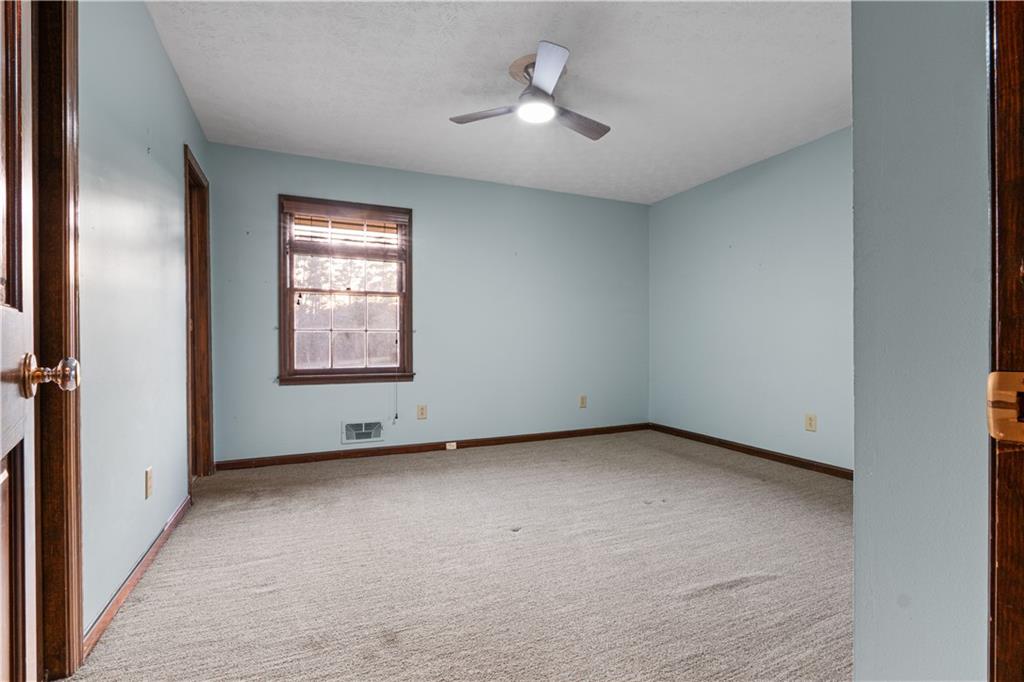 7085 Hobgood Road Fairburn, GA 30213 - Photo 23 of 40 an empty room with windows and fan