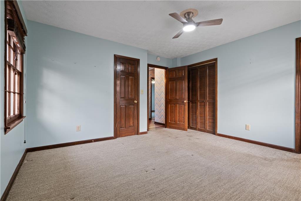 7085 Hobgood Road Fairburn, GA 30213 - Photo 24 of 40 an empty room with closet and a ceiling fan