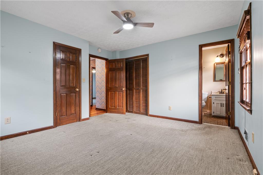 7085 Hobgood Road Fairburn, GA 30213 - Photo 25 of 40 a view of a livingroom with a chandelier fan and windows