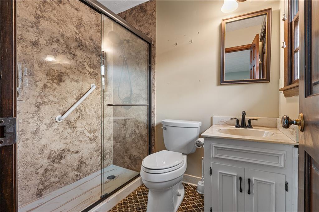7085 Hobgood Road Fairburn, GA 30213 - Photo 26 of 40 a bathroom with a sink toilet and shower