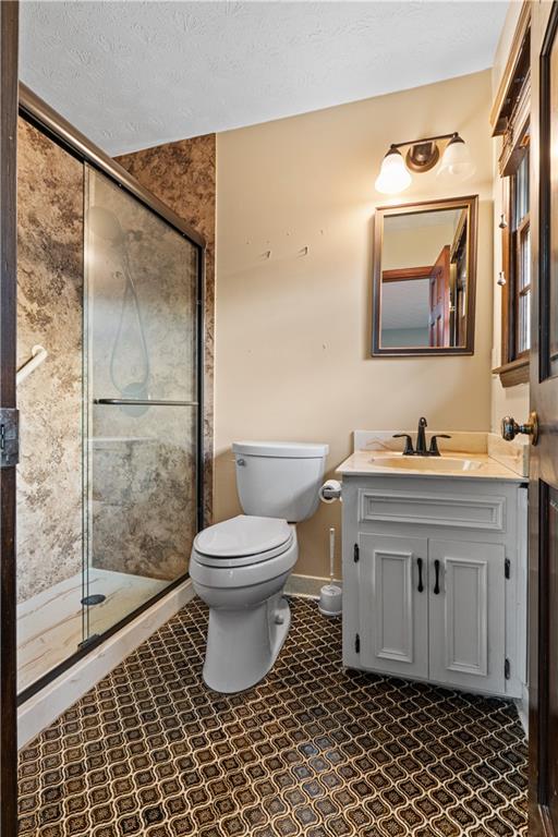 7085 Hobgood Road Fairburn, GA 30213 - Photo 27 of 40 a bathroom with a granite countertop sink toilet a mirror and shower