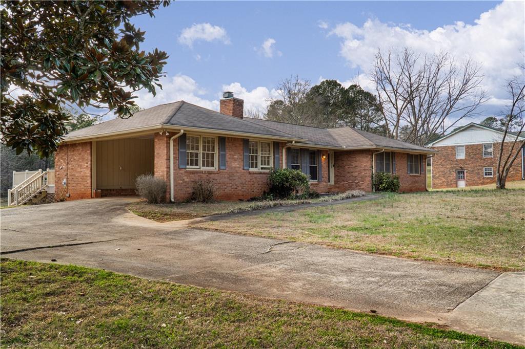 7085 Hobgood Road Fairburn, GA 30213 - Photo 3 of 40 a view of a yard in front of a house with large tree