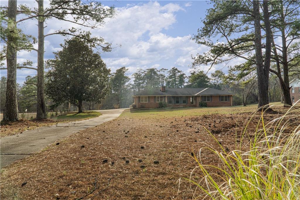7085 Hobgood Road Fairburn, GA 30213 - Photo 35 of 40 a front view of a house with a yard