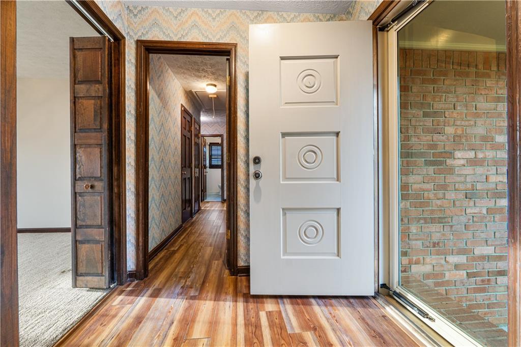 7085 Hobgood Road Fairburn, GA 30213 - Photo 10 of 40 a view of a hallway with wooden floor and staircase