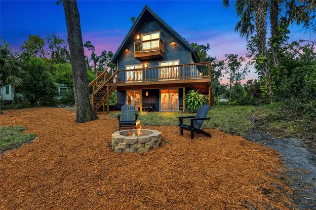 a view of a house with backyard porch and sitting area