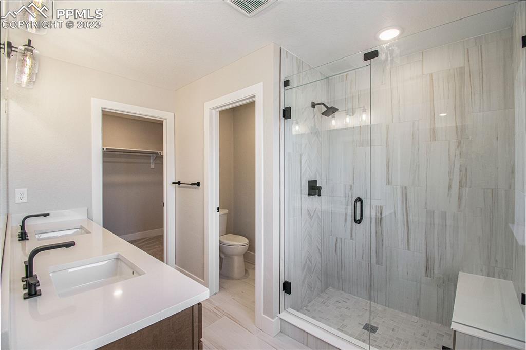 1968 Peridot Loop Heights Colorado Springs, CO 80908 - Photo 4 of 10 a bathroom with a shower sink mirror and toilet