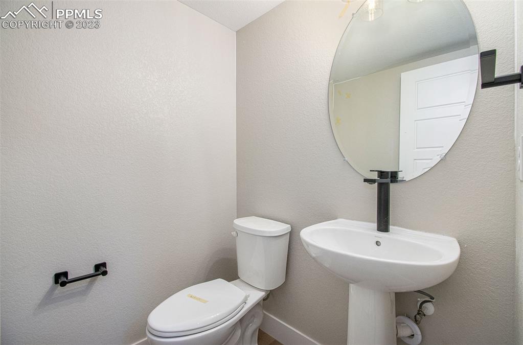 1968 Peridot Loop Heights Colorado Springs, CO 80908 - Photo 8 of 10 a bathroom with a toilet a sink and a mirror