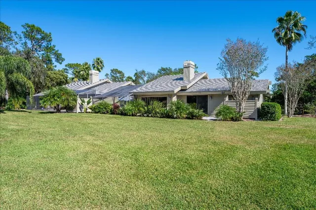 an aerial view of a house with a yard basket ball court and outdoor seating