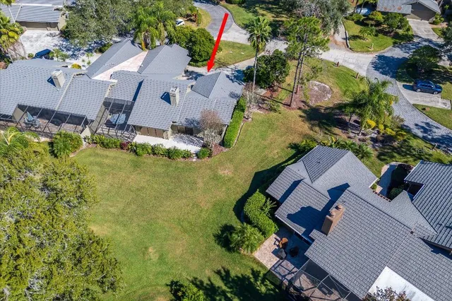 an aerial view of a house with swimming pool and garden