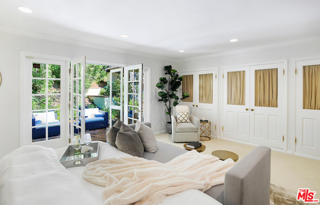 1124 Laurel Way Beverly Hills, CA 90210 - Photo 21 of 31 a living room with furniture and a large window