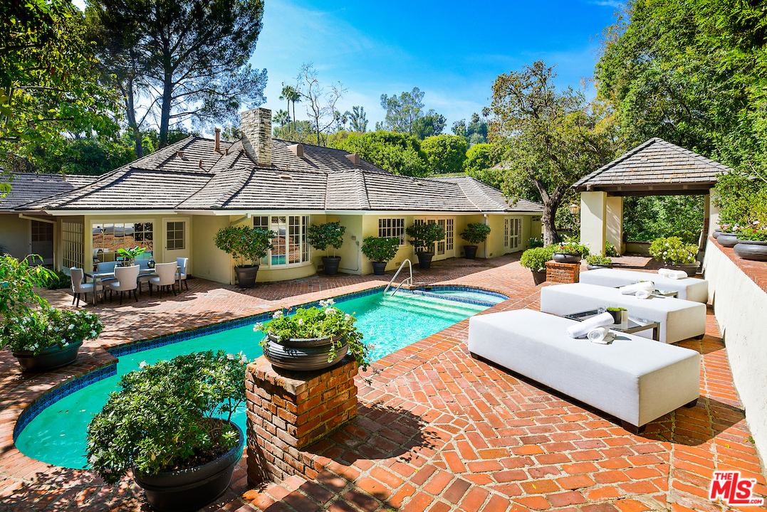 1124 Laurel Way Beverly Hills, CA 90210 - Photo 25 of 31 a view of a patio with couches table and chairs under an umbrella
