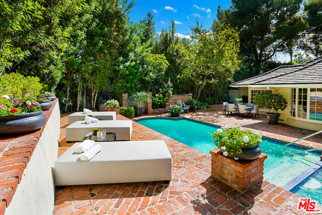 1124 Laurel Way Beverly Hills, CA 90210 - Photo 26 of 31 a view of a patio with couches table and chairs and potted plants