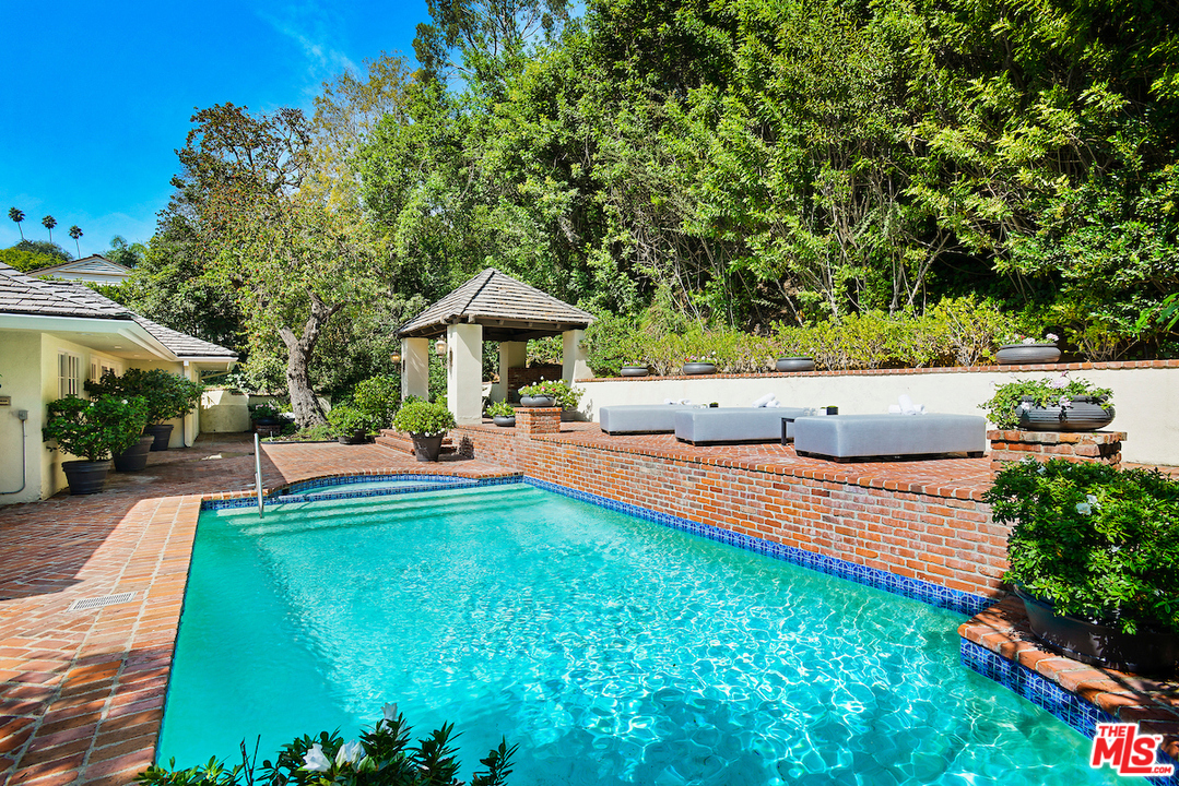 1124 Laurel Way Beverly Hills, CA 90210 - Photo 28 of 31 a view of a swimming pool with an outdoor seating and a garden