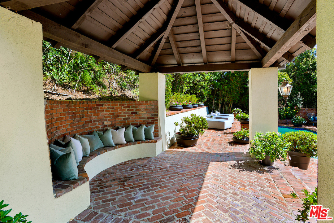 1124 Laurel Way Beverly Hills, CA 90210 - Photo 30 of 31 a view of a porch with furniture and a backyard