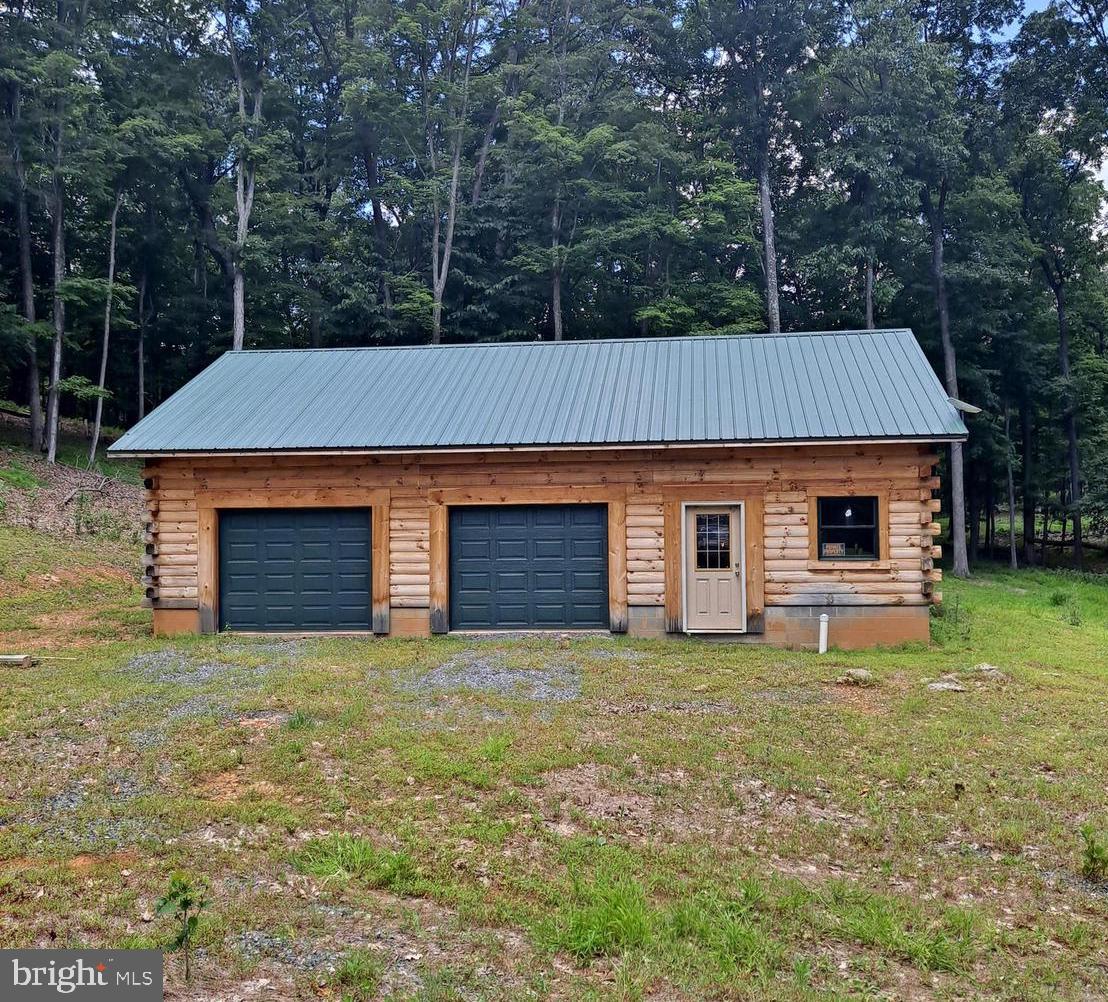 1079 Little Mountain Road Cabins, WV 26855 - Photo 1 of 50 a front view of house with yard and trees in the background