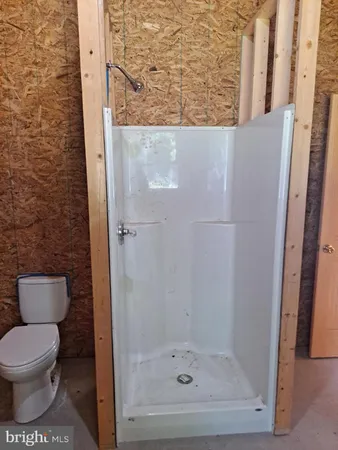a bathroom with a toilet and a shower