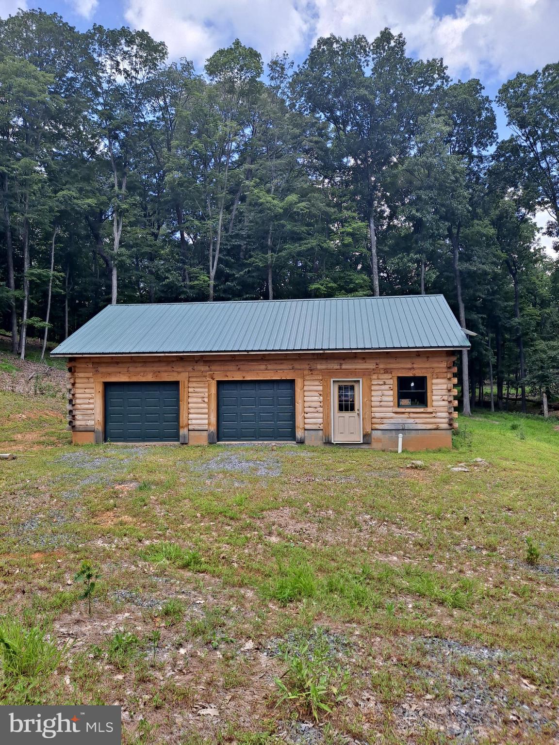 1079 Little Mountain Road Cabins, WV 26855 - Photo 3 of 50 a front view of house with yard and trees