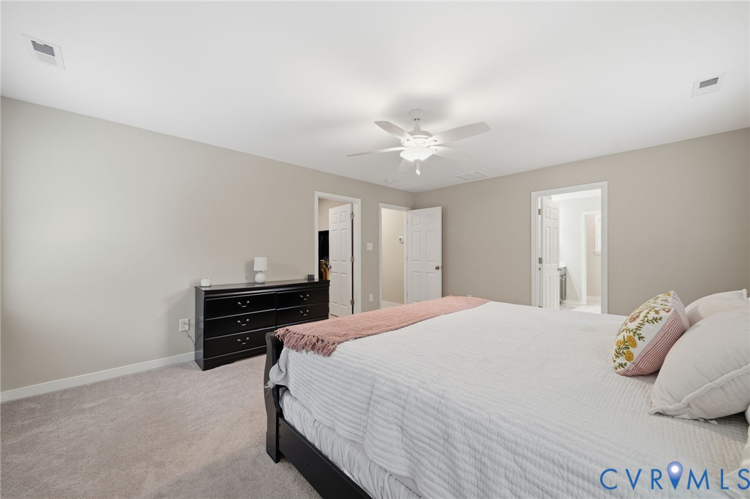 7598 Rural Point Road Mechanicsville, VA 23116 - Photo 23 of 41 a bedroom with a bed and a ceiling fan