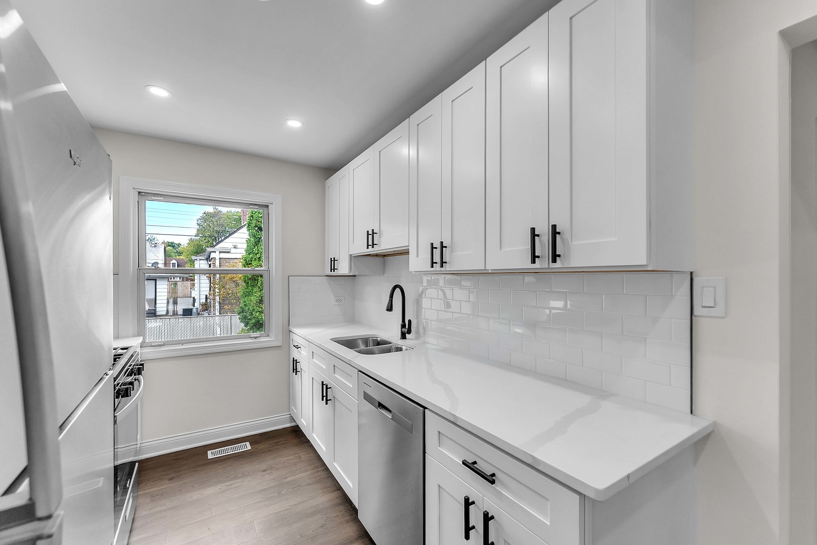 17908 Commercial Avenue Lansing, IL 60438 - Photo 13 of 35 a kitchen with a sink a window and cabinets