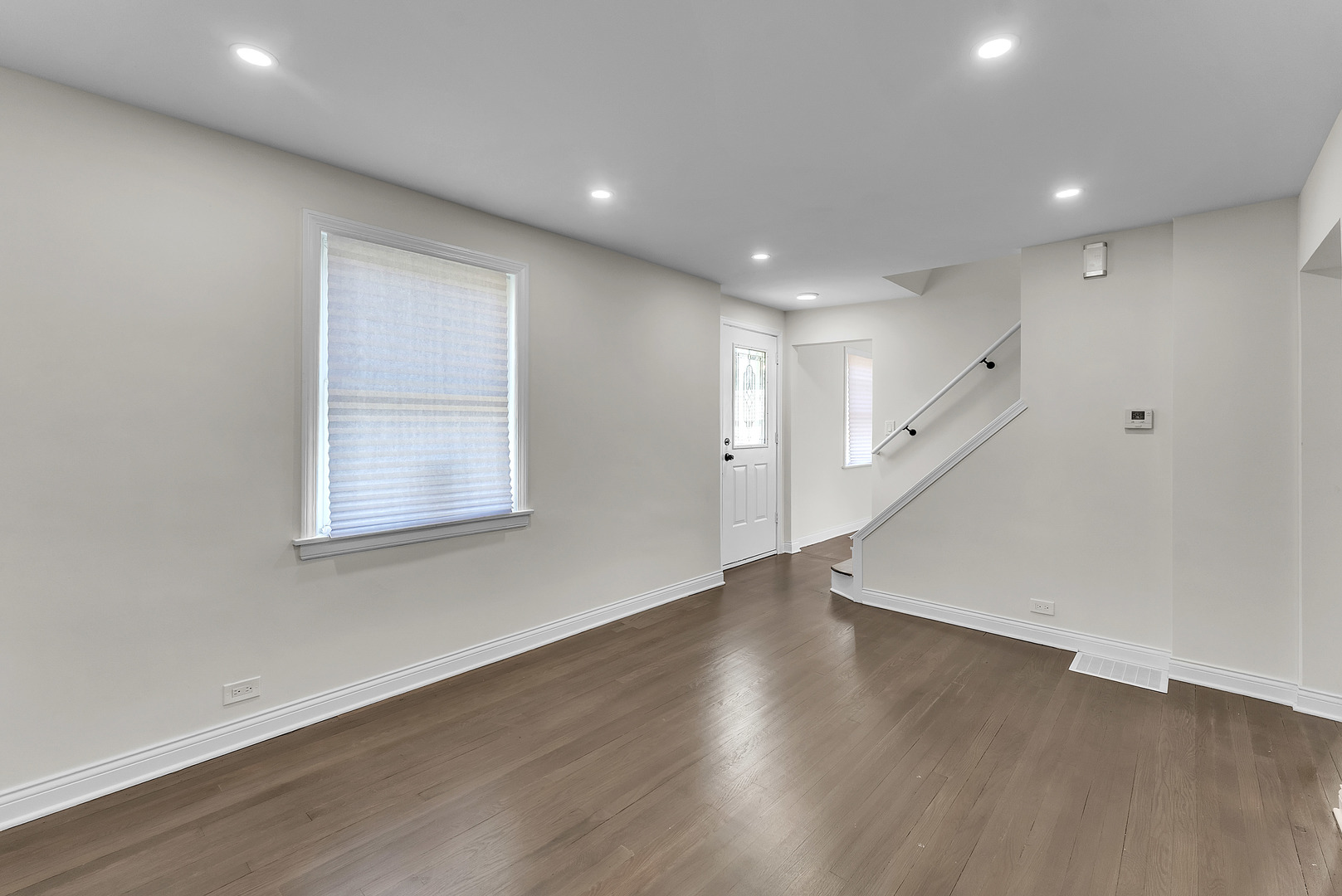17908 Commercial Avenue Lansing, IL 60438 - Photo 6 of 35 an empty room with wooden floor and windows