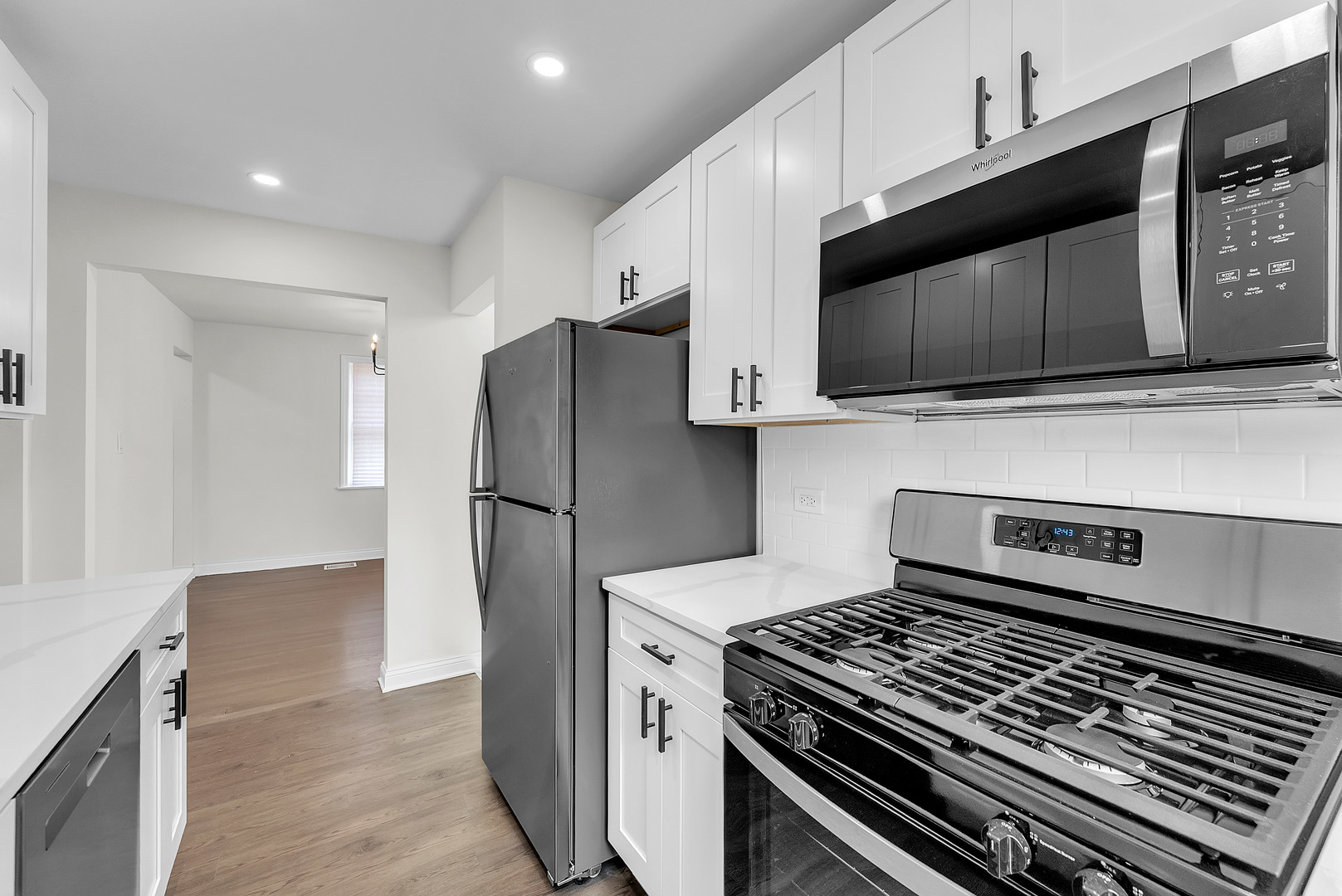 17908 Commercial Avenue Lansing, IL 60438 - Photo 10 of 35 a kitchen with a stove and a microwave