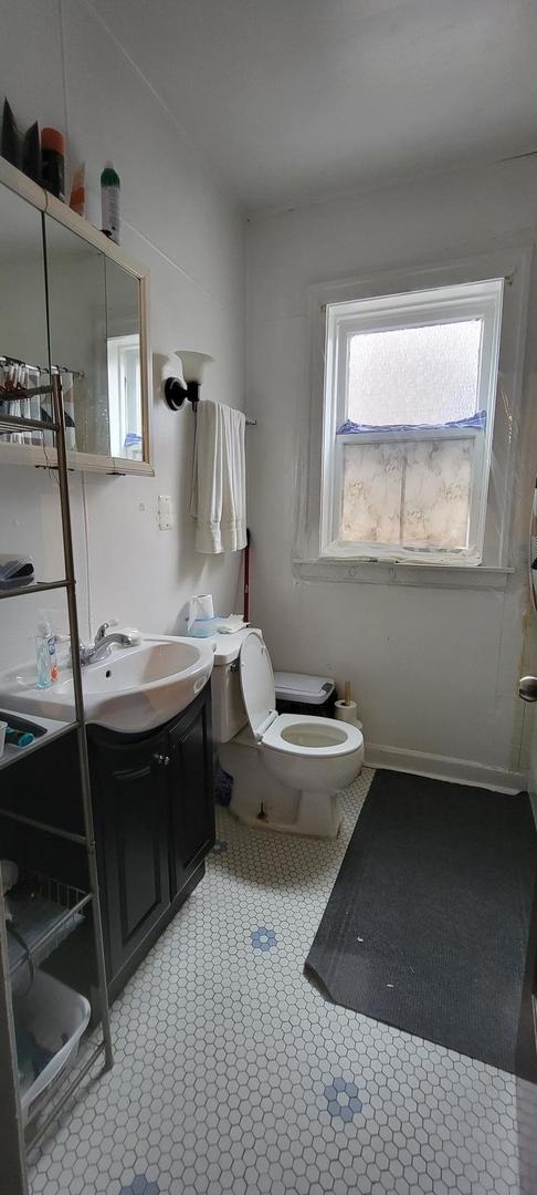 10652 South Ave B Chicago, IL 60617 - Photo 12 of 18 a bathroom with a sink toilet and mirror
