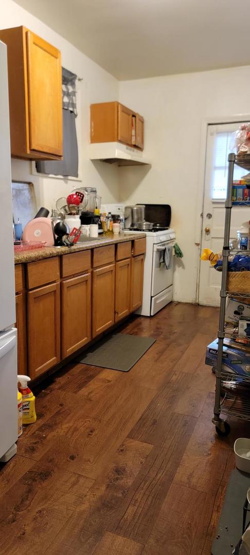 10652 South Ave B Chicago, IL 60617 - Photo 13 of 18 a kitchen with stainless steel appliances a sink stove and cabinets