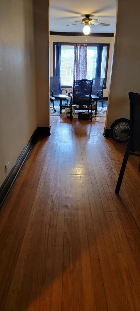 10652 South Ave B Chicago, IL 60617 - Photo 6 of 18 a room with wooden floor and furniture
